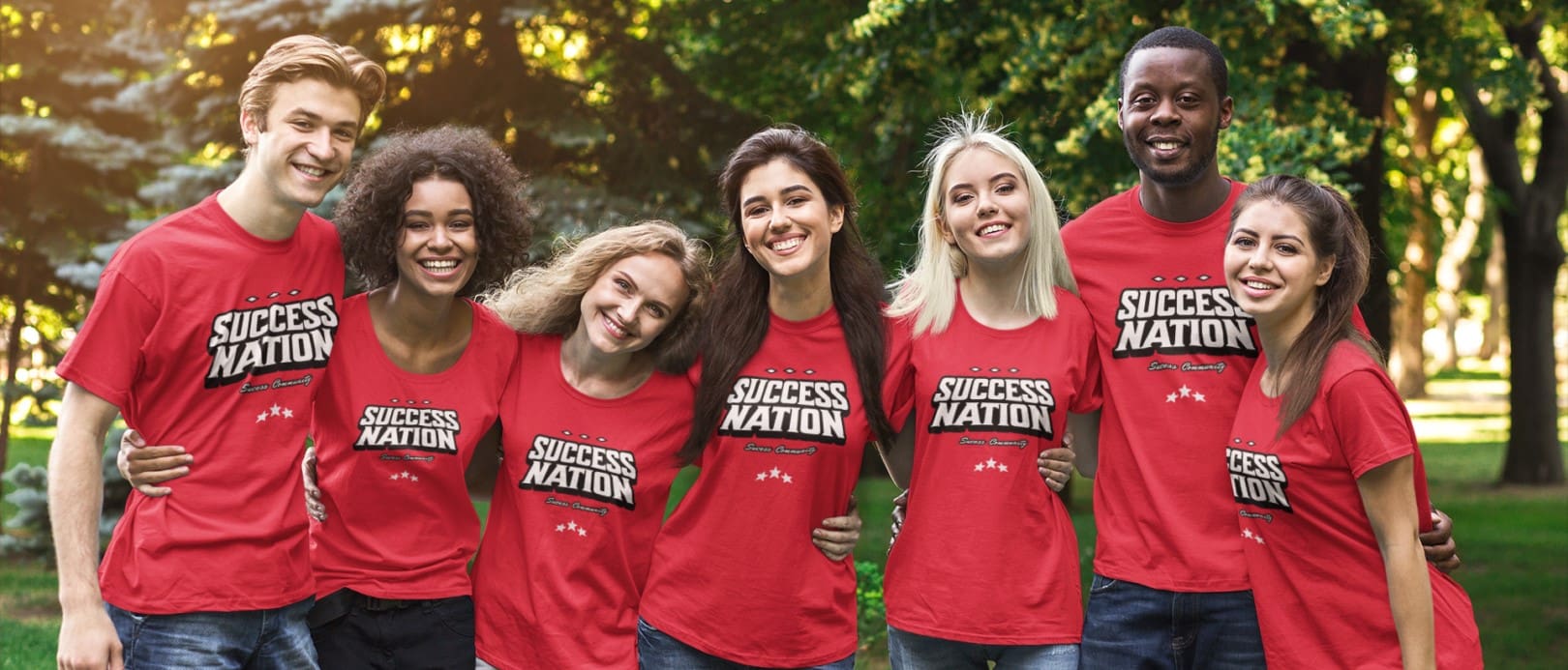 A group of people wearing red shirts and smiling.