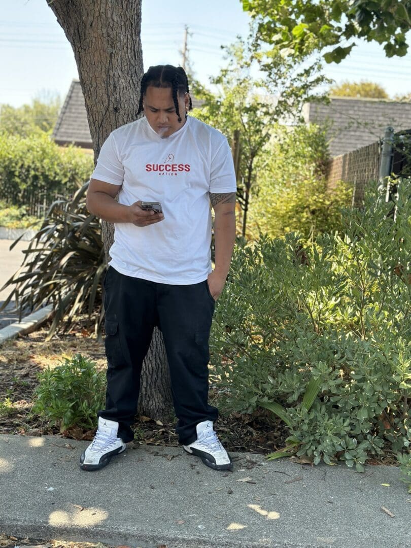 A person standing on the side of a road.